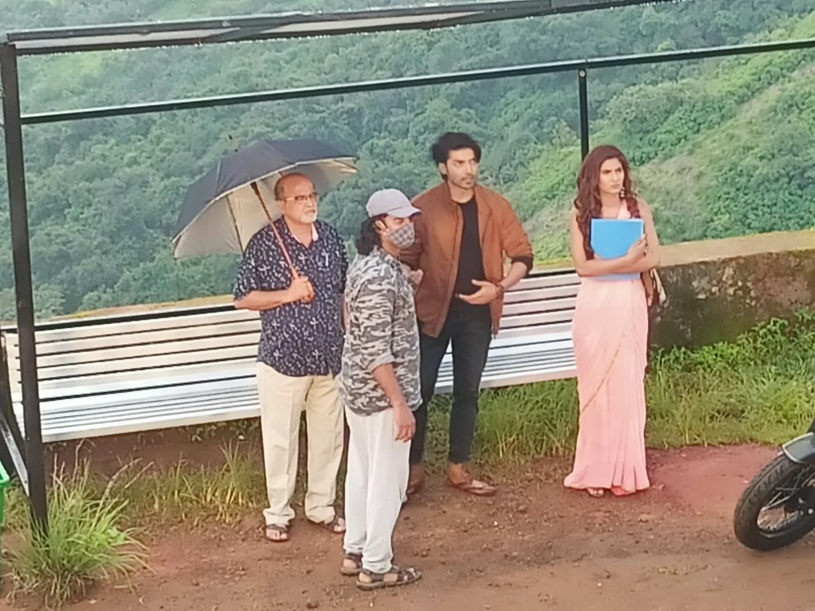 Crew blocking a scene at a valley-edge viewpoint